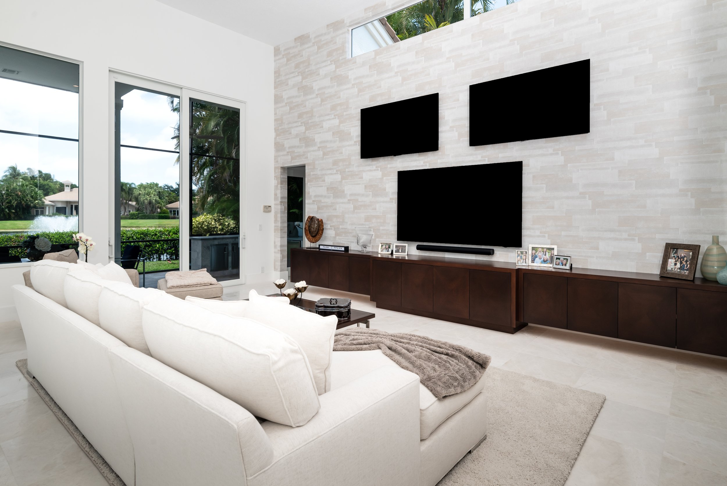 Modern family room with custom media wall and cream sectional