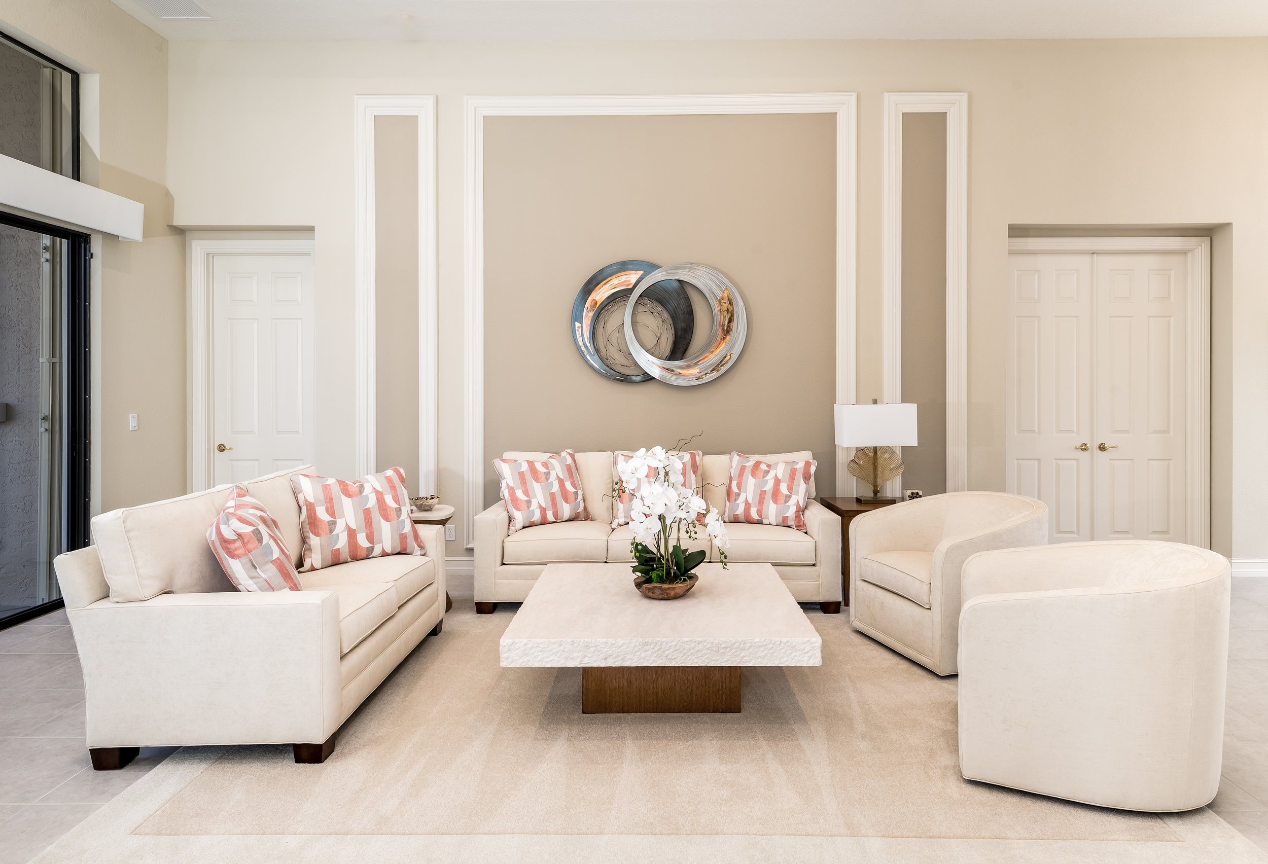 Airy living room with pale seating and stone cocktail table